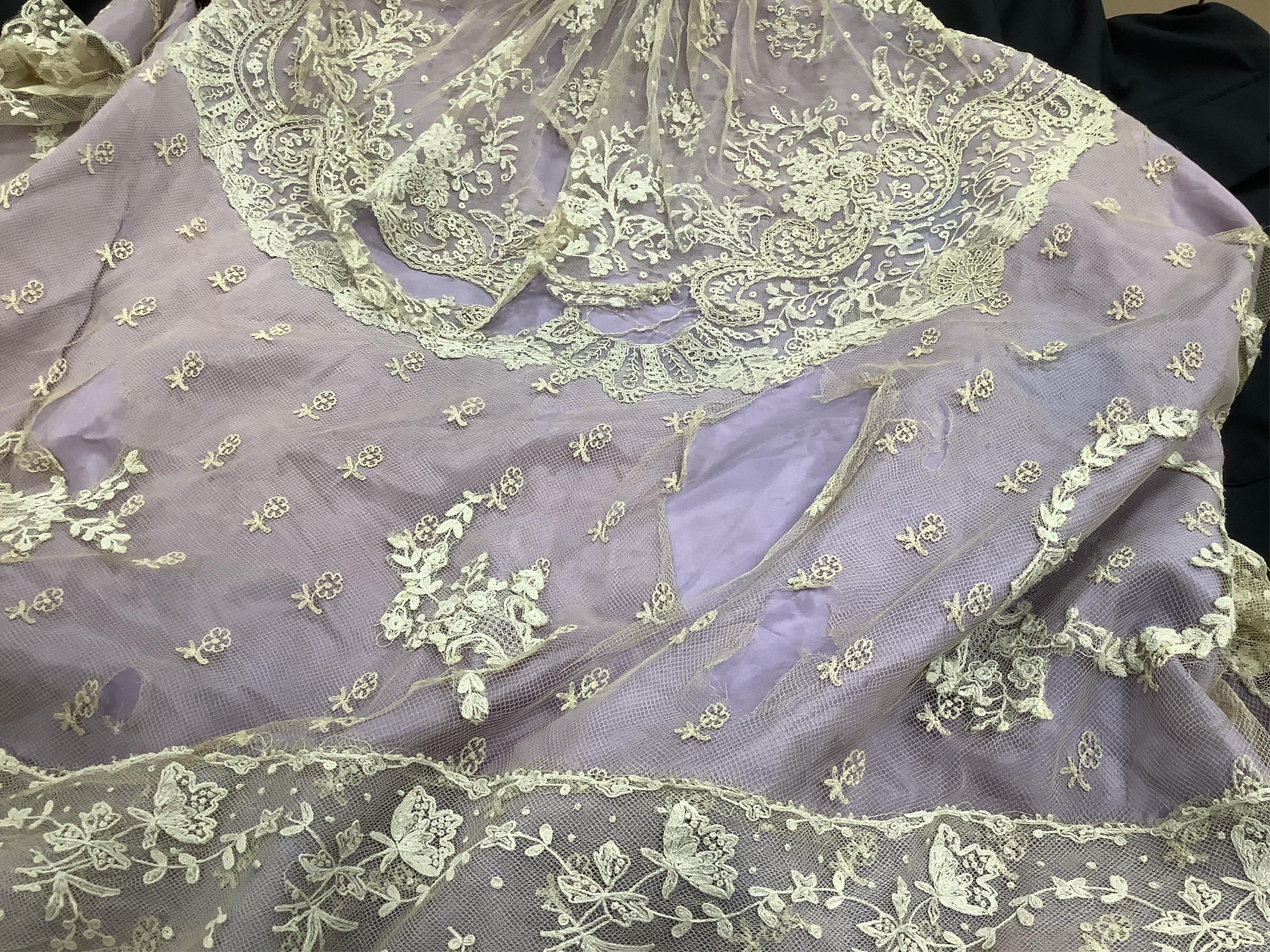 A small late 19th century Brussels wedding veil, an earlier Brussels bobbin bonnet veil, two needle run bonnet veils, various lace sleeves and a lilac silk and lace coverlet., Brussels veil 140cm x 132cm. Condition - the